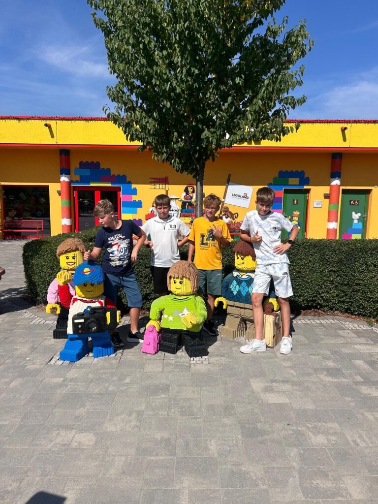 make-a-wish-oesterreich_erfuellte-wuensche_Fabian (9) Vier Jugendliche posieren bei Fabians Make-A-Wish-Wunscherfüllung mit lebensgroßen LEGO-Figuren.